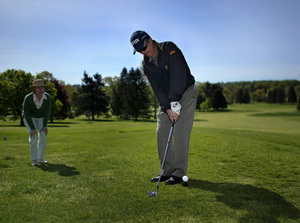 Bruce Hooper gets direction from wife Judy as he putts at Whitemarsh Valley Country Club.