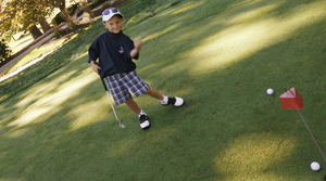 Kyle Lograsso, 5, celebrates a putt. He was a guest of the United States Blind Golf Association at Edgmont Country Club.